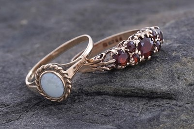 Lot 88 - An opal cabochon ring; and a garnet ring