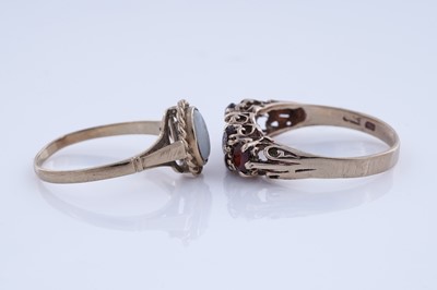 Lot 88 - An opal cabochon ring; and a garnet ring
