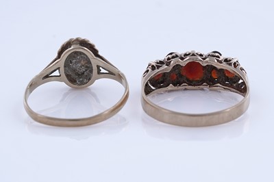 Lot 88 - An opal cabochon ring; and a garnet ring