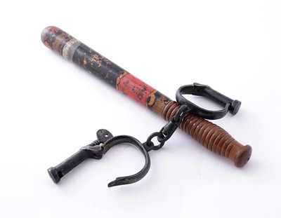 Lot 94 - A Victorian painted truncheon, by Field of Holborn; and a pair of wrought iron handcuffs