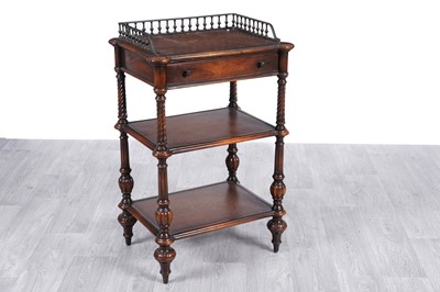 Lot 83 - Attributed to Theodore Alexander: a mahogany three-tier whatnot