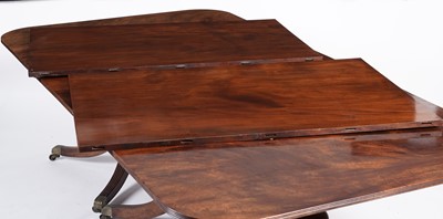 Lot 1057 - A Regency style mahogany three pillar pedestal dining table