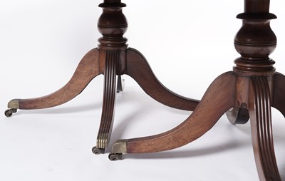 Lot 1057 - A Regency style mahogany three pillar pedestal dining table