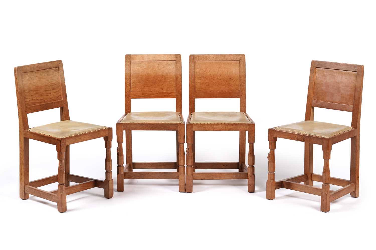 Lot 1073 - Robert ‘Mouseman’ Thompson: a set of four oak panel back dining chairs