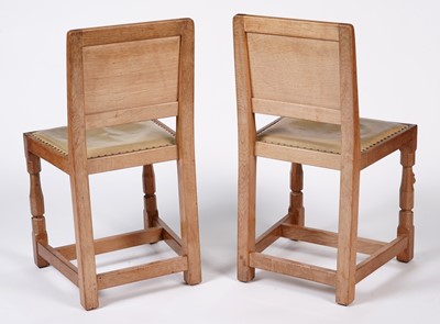 Lot 1073 - Robert ‘Mouseman’ Thompson: a set of four oak panel back dining chairs