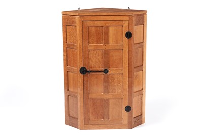 Lot 1076 - Robert ‘Mouseman’ Thompson: an oak hanging corner cupboard