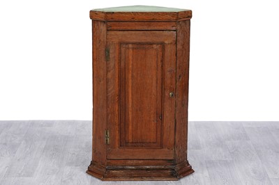 Lot 92 - An early 20th Century oak corner cabinet