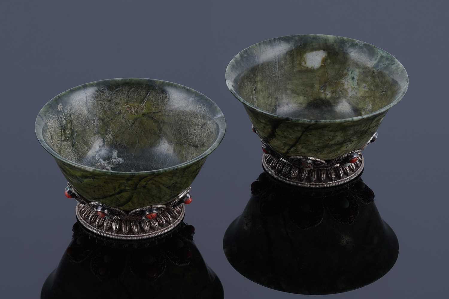 Lot 834 - A pair of Sino-Tibetan spinach green nephrite bowls