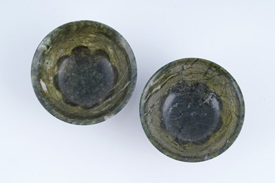 Lot 834 - A pair of Sino-Tibetan spinach green nephrite bowls
