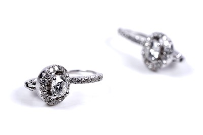 Lot 927 - A pair of diamond cluster earrings