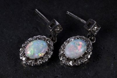 Lot 19 - A pair of opal and diamond pendant earrings