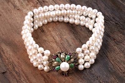 Lot 28 - A ruby, jadeite, and four-strand cultured pearl bracelet
