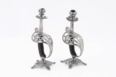 Lot 498 - A pair of early 20th Century cavalry officer’s sword hilt candlesticks