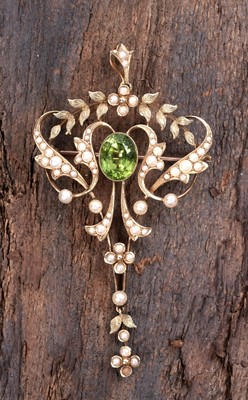 Lot 915 - An Edwardian Art Nouveau peridot and seed pearl pendant/brooch