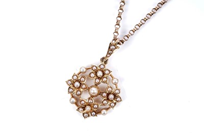 Lot 1 - An Edwardian seed pearl openwork pendant on chain