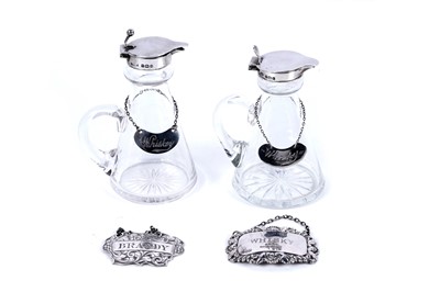 Lot 261 - A pair of early 20th Century silver mounted glass toddy flasks; and bottle labels