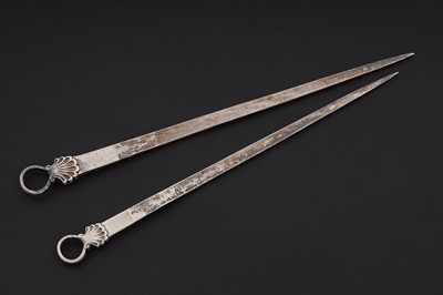 Lot 204 - A graduated pair of George III silver meat skewers