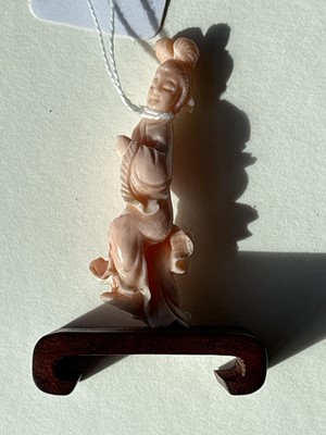 Lot 832 - A Chinese pink coral figure; and a bamboo section carving