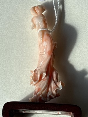 Lot 832 - A Chinese pink coral figure; and a bamboo section carving