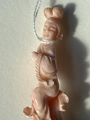 Lot 832 - A Chinese pink coral figure; and a bamboo section carving
