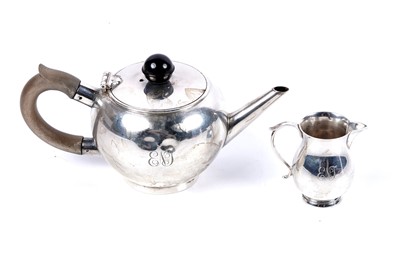 Lot 183 - A George VI silver miniature bullet form teapot and cream jug
