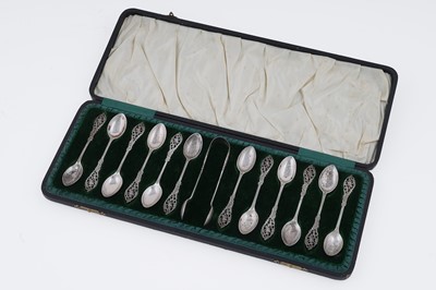 Lot 174 - An Edwardian cased set of twelve silver Rococo Revival coffee spoons and sugar tongs