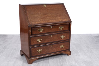Lot 61 - A George III oak and mahogany banded bureau