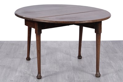 Lot 59 - A Georgian and later oak drop leaf dining table