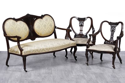 Lot 71 - An early 20th Century carved walnut sofa; and two similar armchairs