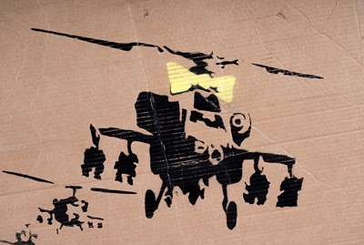 Lot 692 - BANKSY - "Happy Choppers" (Wrong War) | spray paint on cardboard