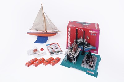 Lot 608 - A Wilesco D-18 stationary tin plate live steam engine; and a ‘Star Yacht’ model pond yacht