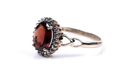 Lot 58 - A garnet and diamond cluster ring