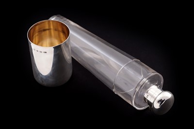 Lot 129 - A late Victorian silver-mounted clear glass hunting flask; and a drinking cup