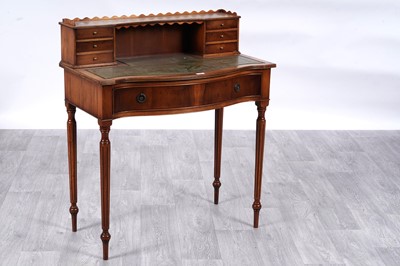 Lot 17 - Burton Reproductions Ltd: a walnut serpentine lady’s writing desk