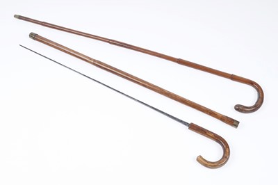 Lot 548 - A continental cane swordstick; and a walking cane with white metal plaque