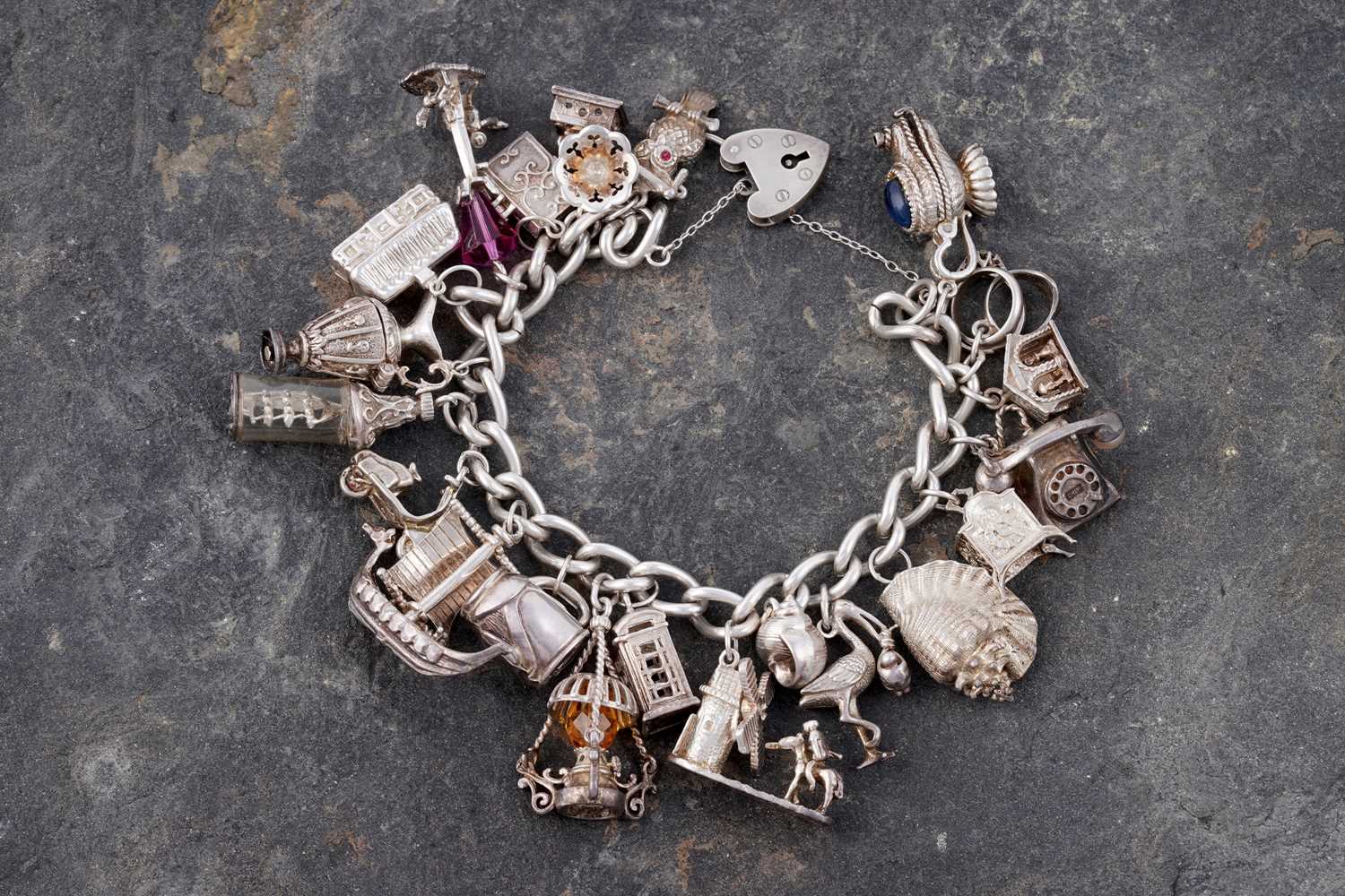 Lot 110 - A silver curb-link novelty charm bracelet