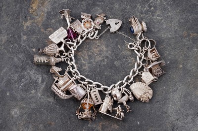 Lot 110 - A silver curb-link novelty charm bracelet