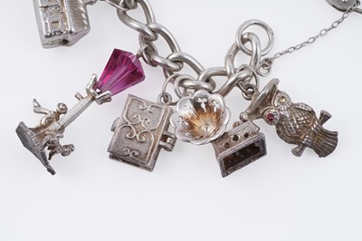Lot 110 - A silver curb-link novelty charm bracelet