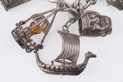 Lot 110 - A silver curb-link novelty charm bracelet