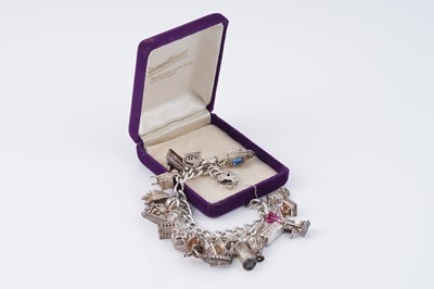 Lot 110 - A silver curb-link novelty charm bracelet