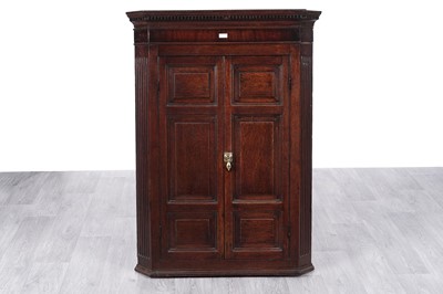 Lot 7 - A George III oak corner cabinet