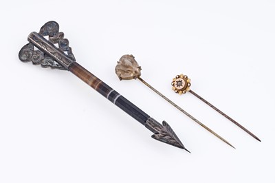 Lot 14 - A Victorian arrow-pattern banded agate brooch; and two stick pins