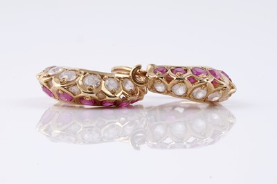 Lot 135 - A pair of Indian gold, ruby and white sapphire hoop earrings