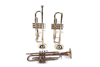 Lot 367 - An Elkhart series II lacquered brass trumpet; and two others