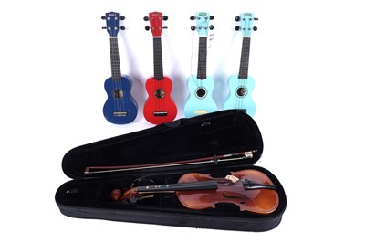 Lot 375 - A Kapok student violin; and four Ukuleles