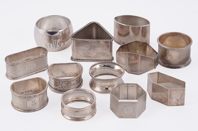 Lot 323 - A collection of George V and later silver napkin rings with engine-turned decoration