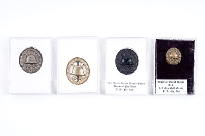 Lot 853 - Four German First World War wound badges