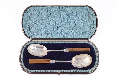 Lot 285 - A Victorian cased pair of silver serving spoons influenced by the Aesthetic Movement