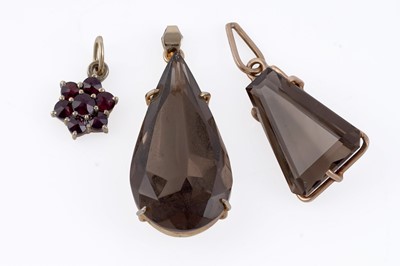 Lot 181 - Two smoky quartz pendants; and a garnet cluster pendant