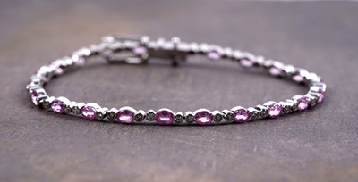 Lot 873 - A pink sapphire and diamond bracelet